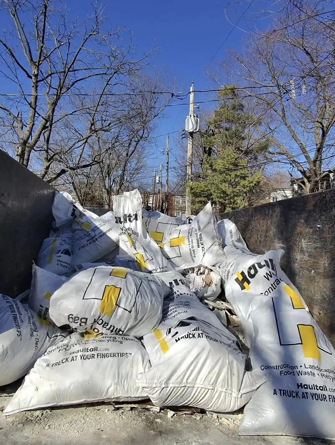 Truck bed packed with full bags of construction debris
